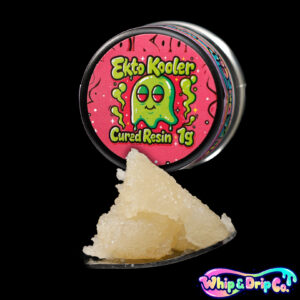 “Whip & Drip Co. Ekto Kooler cured resin concentrate with golden extract displayed beside citrus-themed 1 gram product packaging on a black background.”